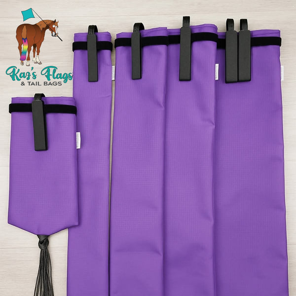Purple range of tail bags with black velcro on a light wooden background, featuring Kaz's Flags & Tail Bags logo.