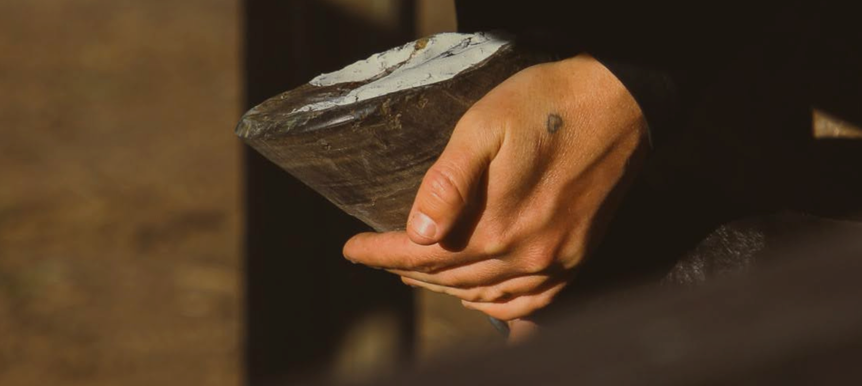 Farrier holding a foot that has been treated with the Equid Apothecary's EquiMud Hoof pack.