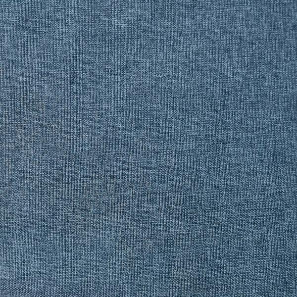 A close-up texture shot of a blue woven fabric, showing a detailed linen-like weave pattern.