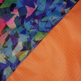 Close-up of colorful geometric patterned fabric and orange textured fabric of the Fusion Flag