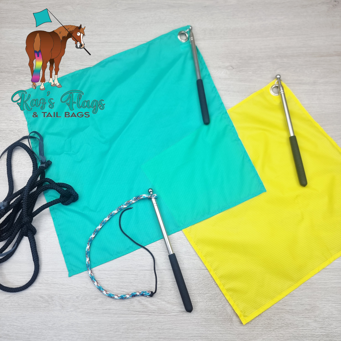 Two rectangular tail flags in bright turquoise and yellow, each with a metal grommet and attached pole, plus two rope tails and a small horse-and-flag logo watermark reading 'Kaz's Flags & Tail Bags' on a light wood surface.