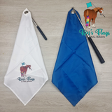 Two flags, one white and one blue, with 'Kaz's Flags & Tail Bags' branding on a wooden surface.