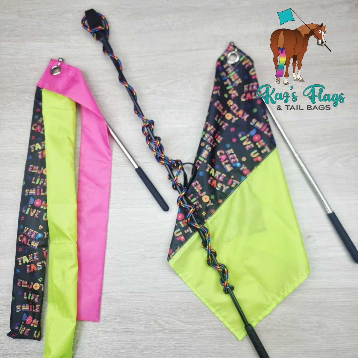 Two colorful flags with handles on a light gray background, featuring the brand 'Kaz's Flags & Tail Bags'.
