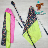 Two colorful flags with handles on a light gray background, featuring the brand 'Kaz's Flags & Tail Bags'.