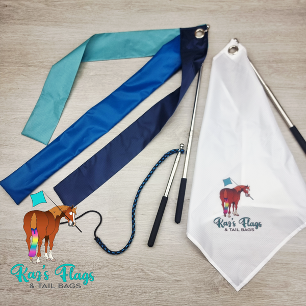 A set of equestrian flag accessories laid out on a light wood surface, including a white flag with logo, blue and teal strippy flags and a liberty whip combo. A logo for 'Kaz's Flags & Tail Bags' appears in the lower left.