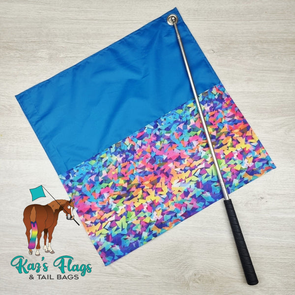 Colorful flag with a blue top and multicolored bottom on a wooden surface, featuring Kaz's Flags & Tail Bags branding.