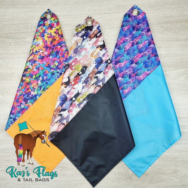 Three colorful horse Fusion flags with different patterns on a wooden surface, branded as Kaz's Flags & Tail Bags.