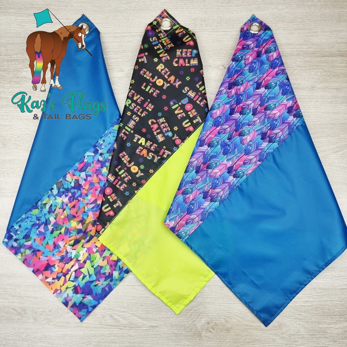 3 colorful horsemanship flags "Fusion Flags" on a wooden surface