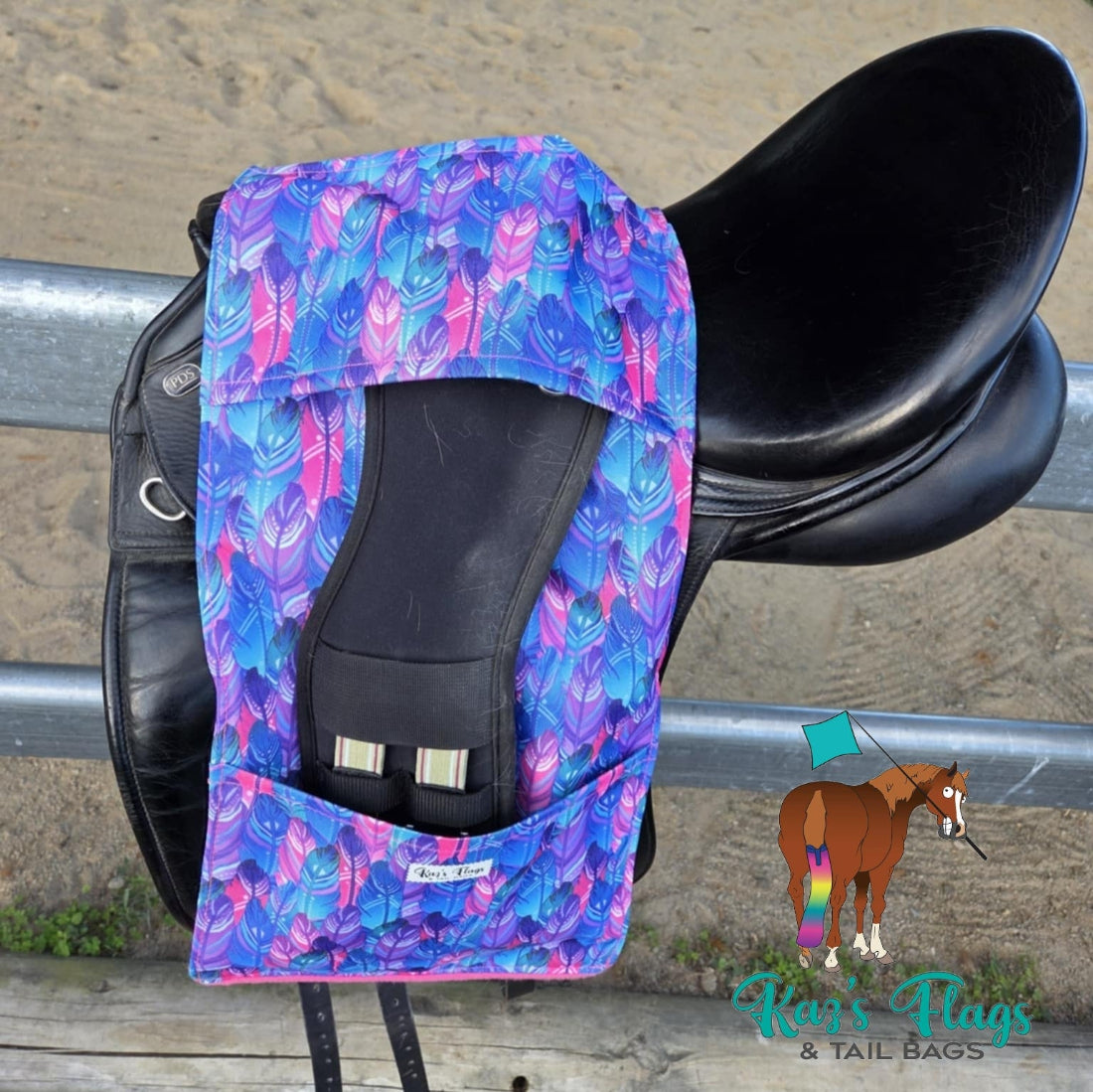 Colourful Stirrup and Girth Holder sitting over a saddle in an outdoor equestrian setting