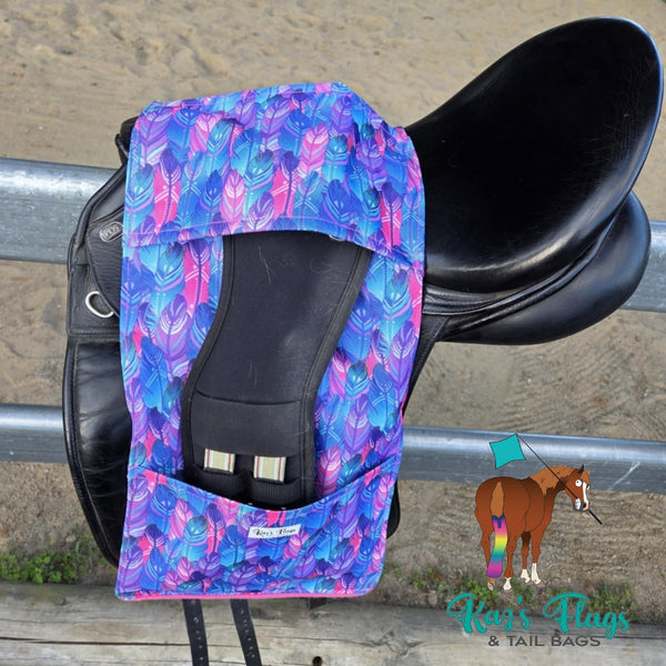 Colourful Stirrup and Girth Holder sitting over a saddle in an outdoor equestrian setting