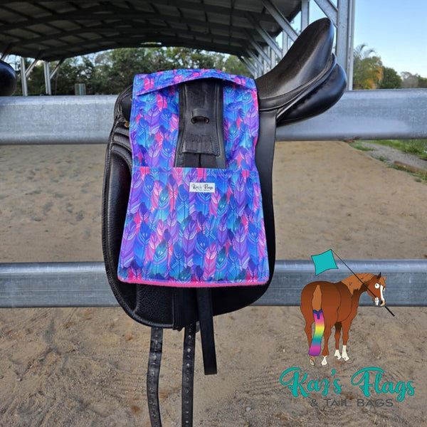 Colourful Stirrup and Girth Holder sitting over a saddle in an outdoor equestrian setting