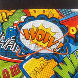 A close-up of a vibrant comic book style print featuring a central 'WOW!' speech bubble with yellow, orange, blue, and white halftone patterns, surrounded by bold comic text and colorful panels.